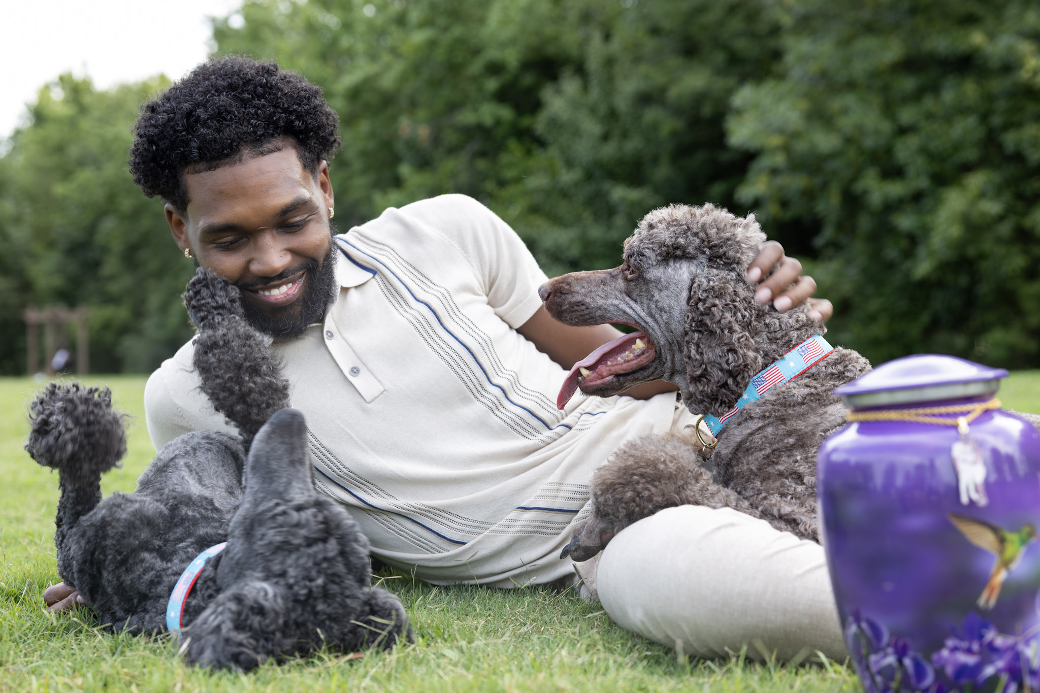 Man laying down with companion dogs